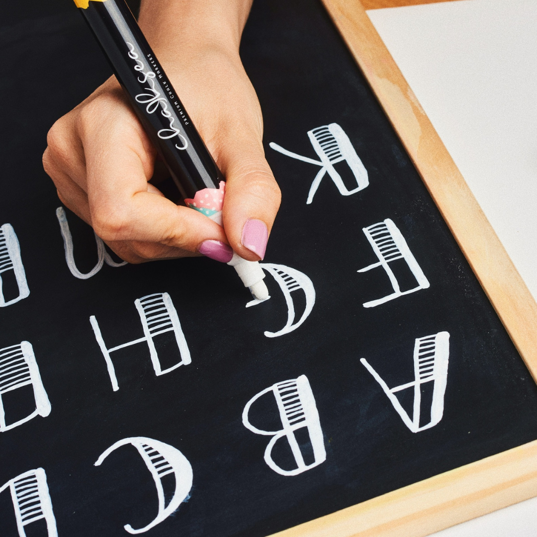 white chalk marker writing on chalkboard